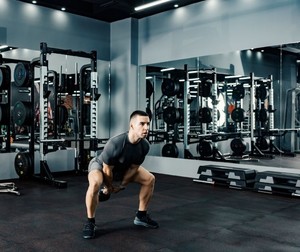 Man performing kettle bell swing