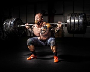 man performing heavy squat for back pain