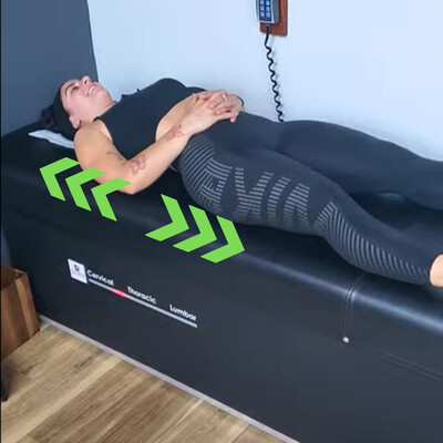 woman using a decompression traction table to relieve sciatic symptoms.   