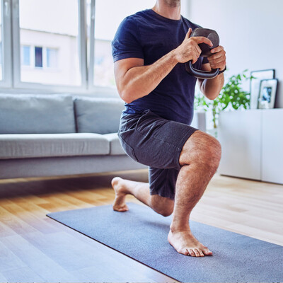 Man performing a squat lunge to rehab low back pain