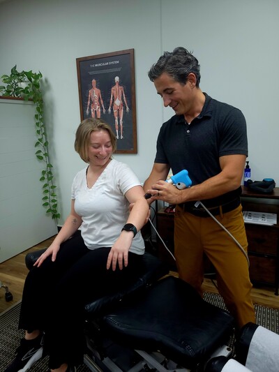 Tampa Chiropractor performing shockwave therapy for elbow pain