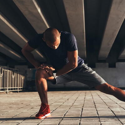 man performing hip flexor stretch to improve mobility after an injury