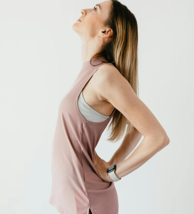 pregnant woman holding low back prior to chiropractic adjustment