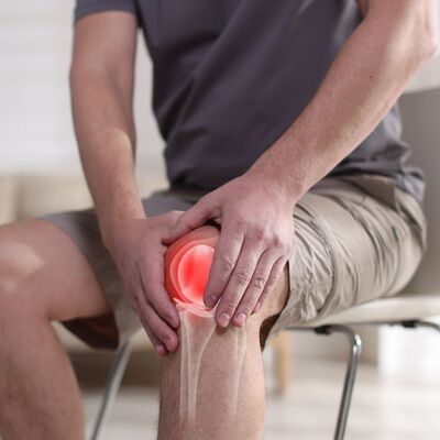 image of an athlete holding his knee after a sports injury