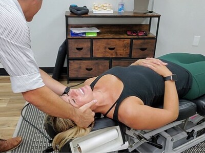 athletic woman getting a neck adjustment by a sports chiropractor
